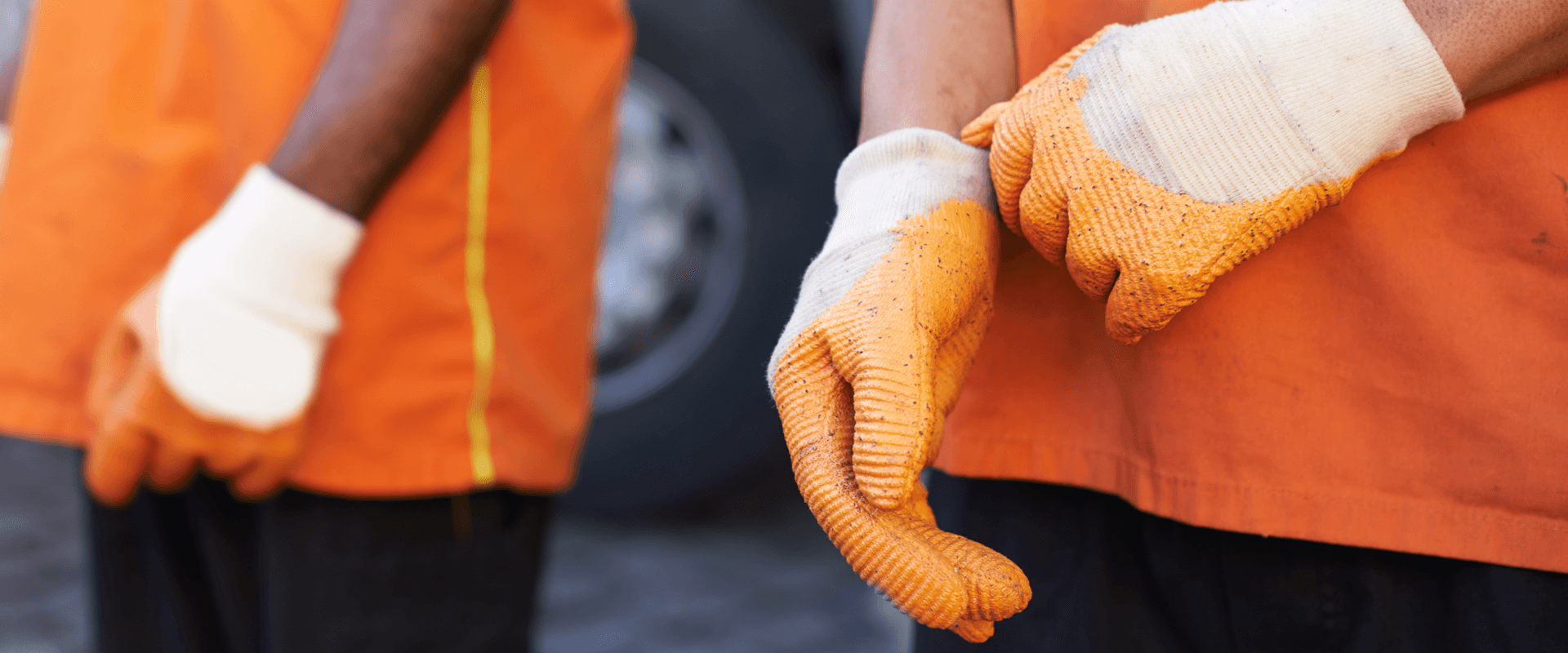 Close up shot of workers wearing safety gloves